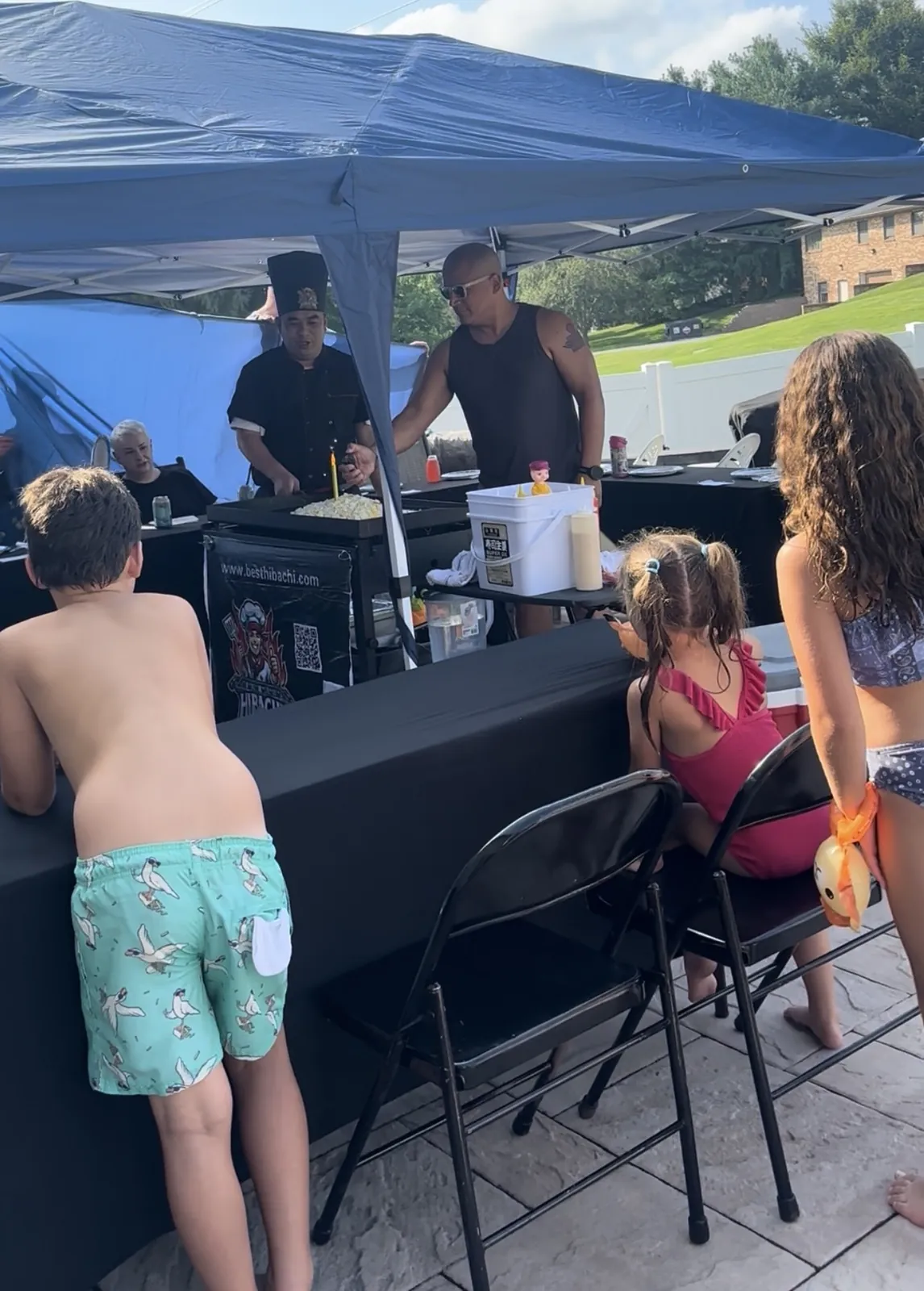 Hibachi to You backyard party with a private chef, portable grill, tables and chairs